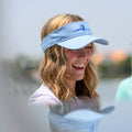 Woman laughing and smiling while wearing a wahoo Pole Dancer Riding East Cotton Visor.